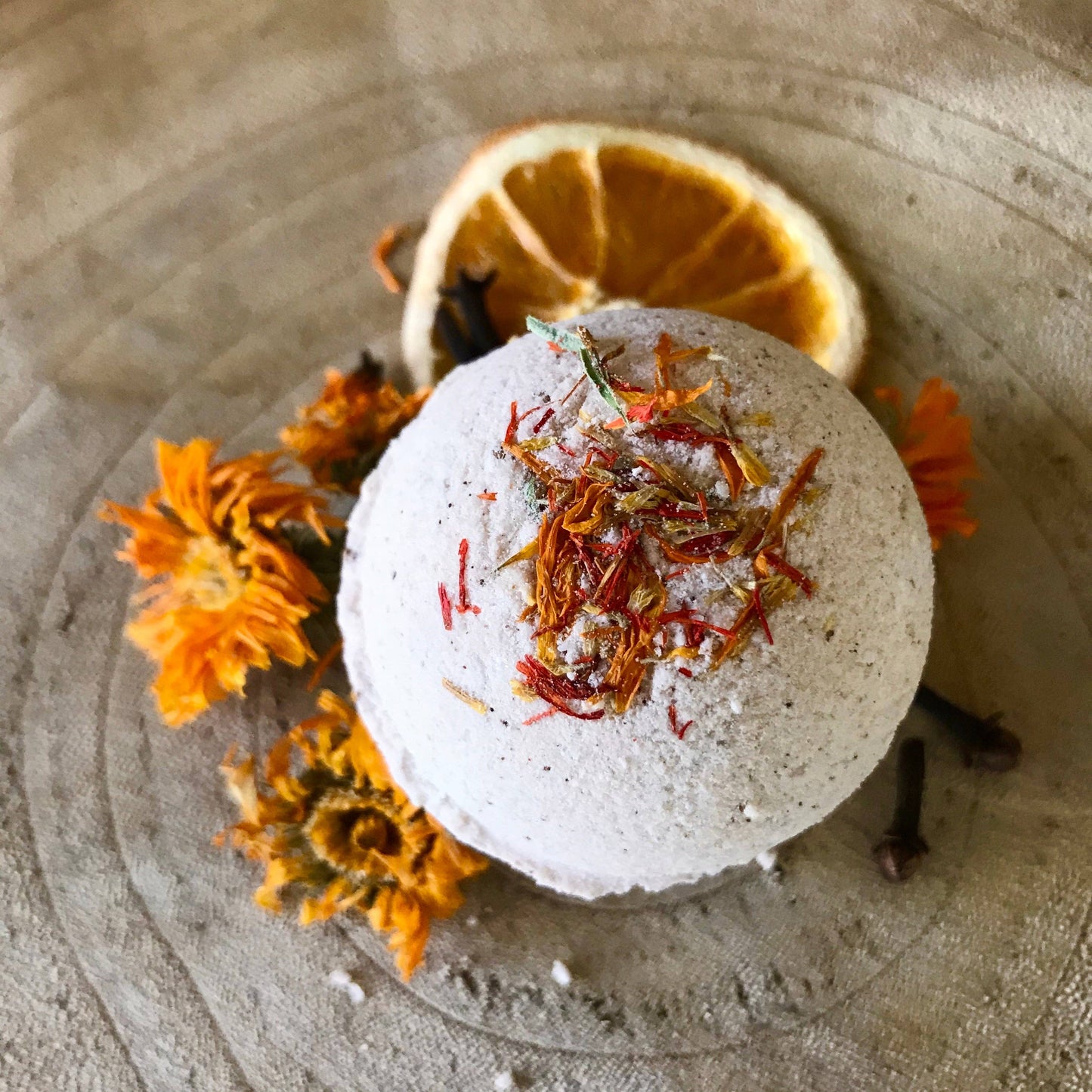 Pomander Bath Bomb, medium size with warm, seasonal scents of wild orange, frankincense, and clove, perfect for grounding and relaxation in bath rituals. Top Photo.