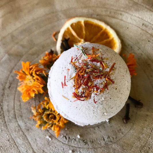 Pomander Bath Bomb, medium size with warm, seasonal scents of wild orange, frankincense, and clove, perfect for grounding and relaxation in bath rituals. Top Photo.