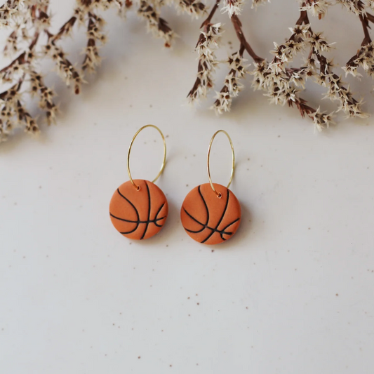 A pair of handcrafted Basketball Hoop Earrings made from polymer clay with 18k gold-plated hardware, displayed against a white background. Lightweight and hypoallergenic.