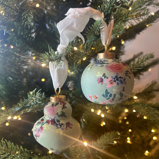 Hand Painted Ornament by Kate Nelson with floral brushstrokes and chiffon ribbon, each unique, and packaged in a linen bag for gifting and storage.