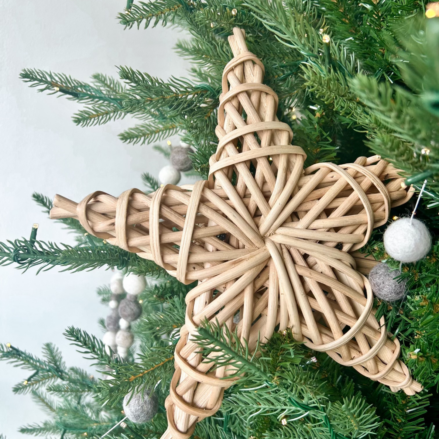 Handcrafted wood star tree topper with woven adding natural, organic charm to holiday decor.