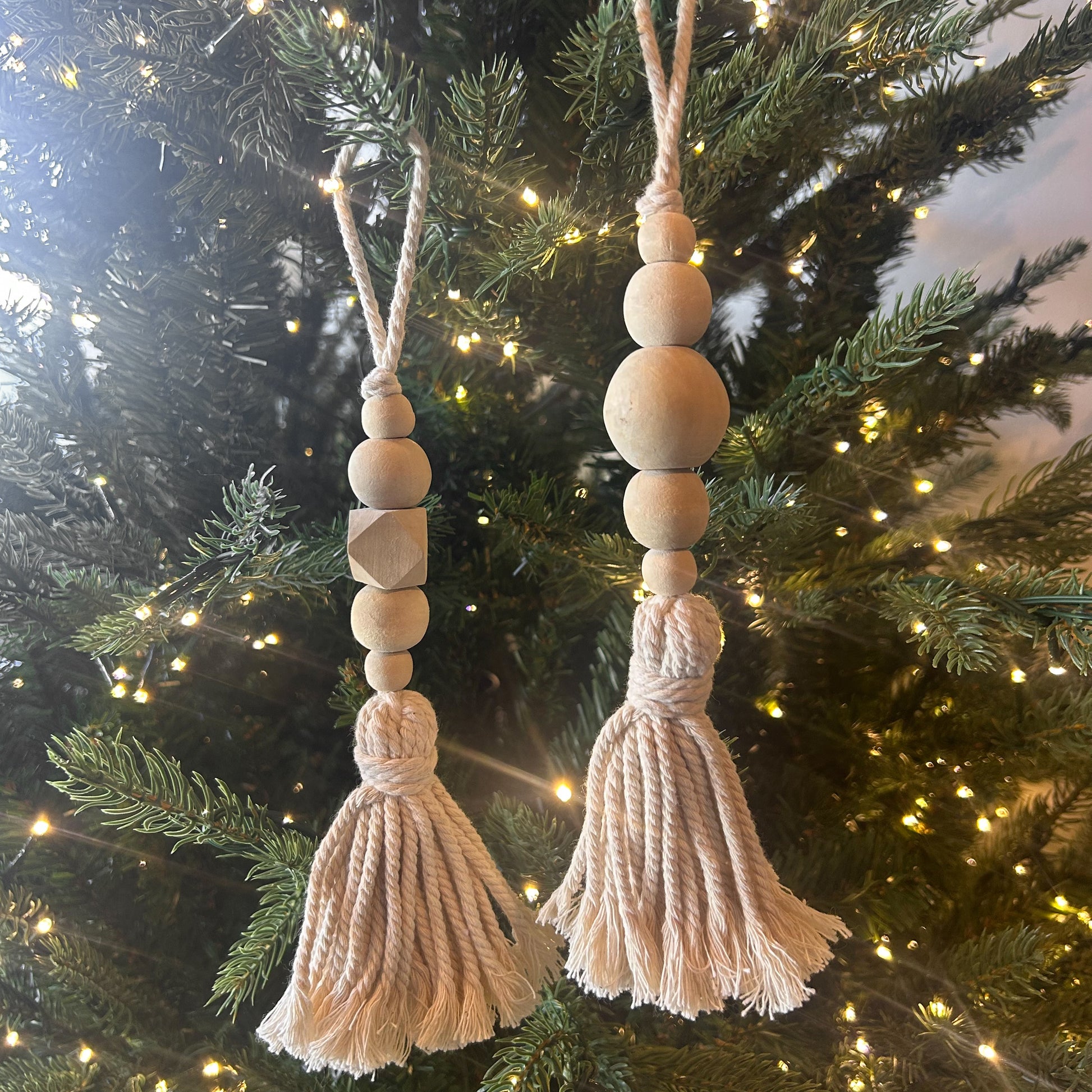 Beaded wood tassel ornament with round and geometric wood beads, cream rope tassel, handcrafted in Bali for holiday or home decor.